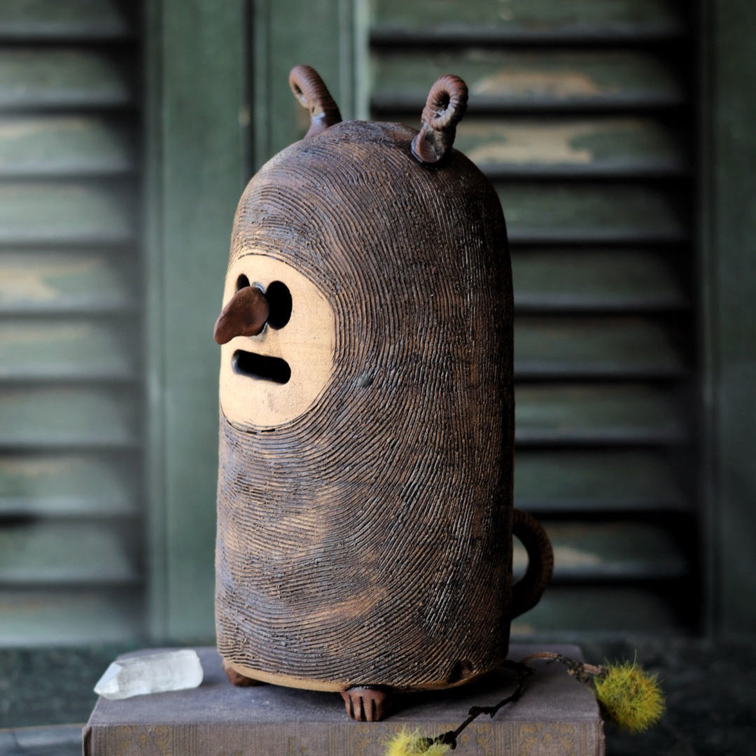 Woodland creature on a book titled 'The Red Badge of Courage' with a rustic background