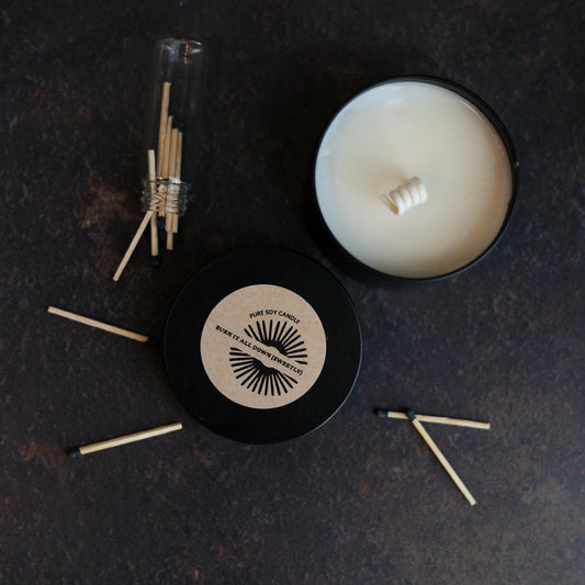 Pure soy Candle with matches on a dark surface