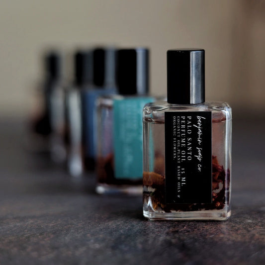 Row of perfume bottles on a textured surface with a blurred background