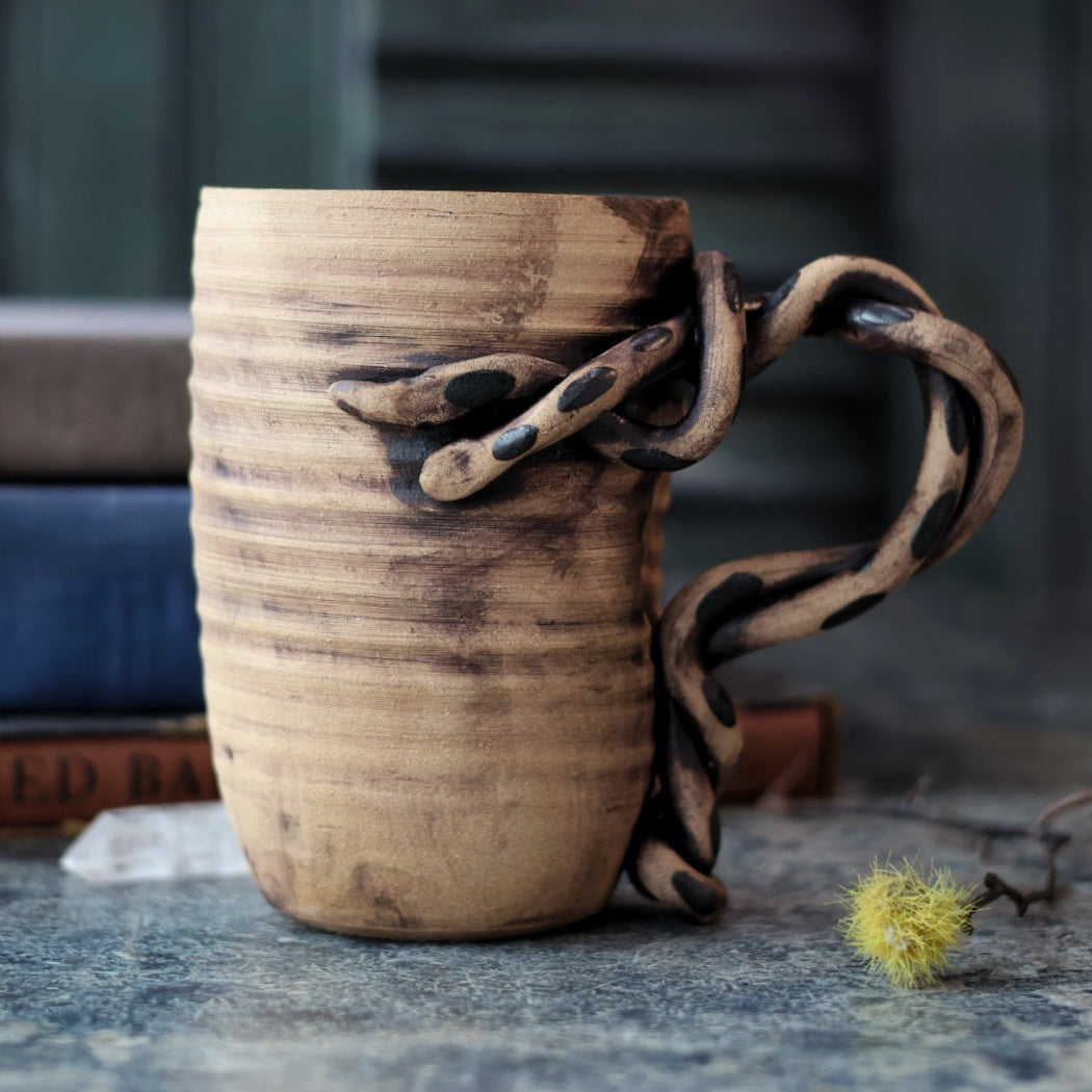 Ceramic handmade mug with a handle made to look like 2 intertwined snakes