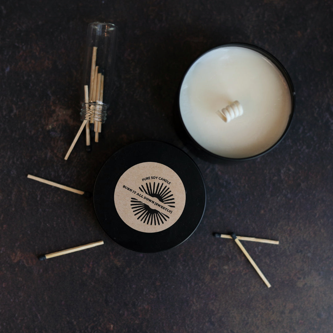 Pure soy Candle with matches on a dark surface