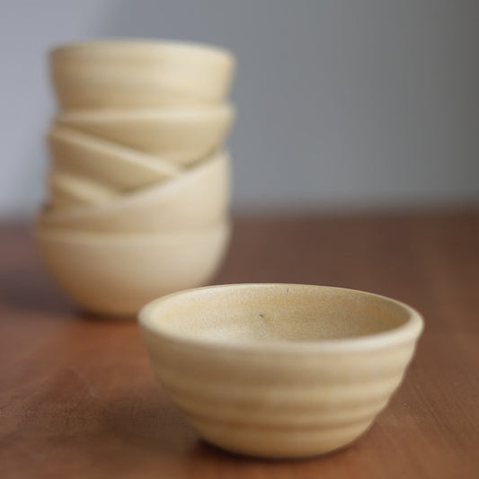 Beige ceramic bowl on wood surface