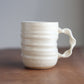 Cream ceramic handmade jumbo companion mug with ribbed design on a wooden surface