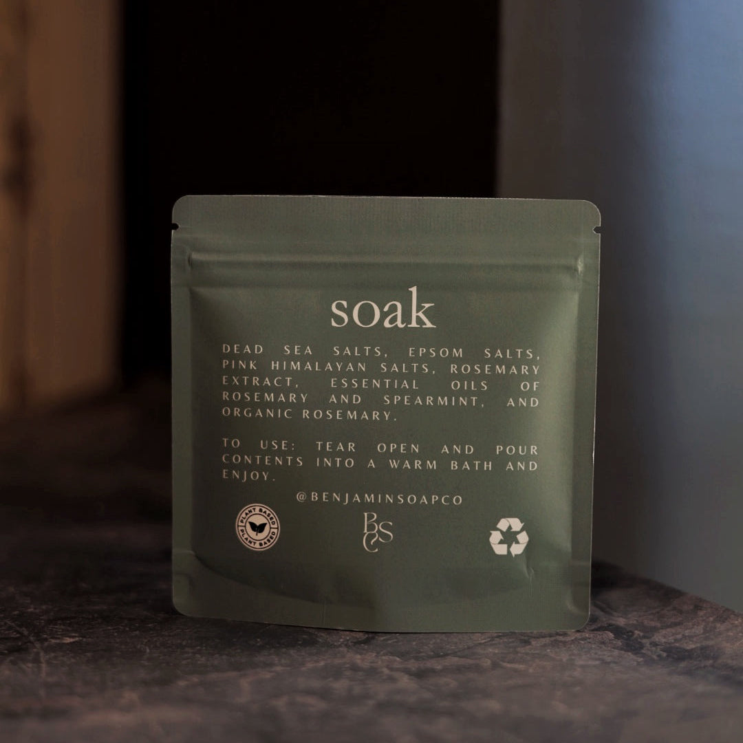Green package labeled 'soak' on a dark surface with a blurred background