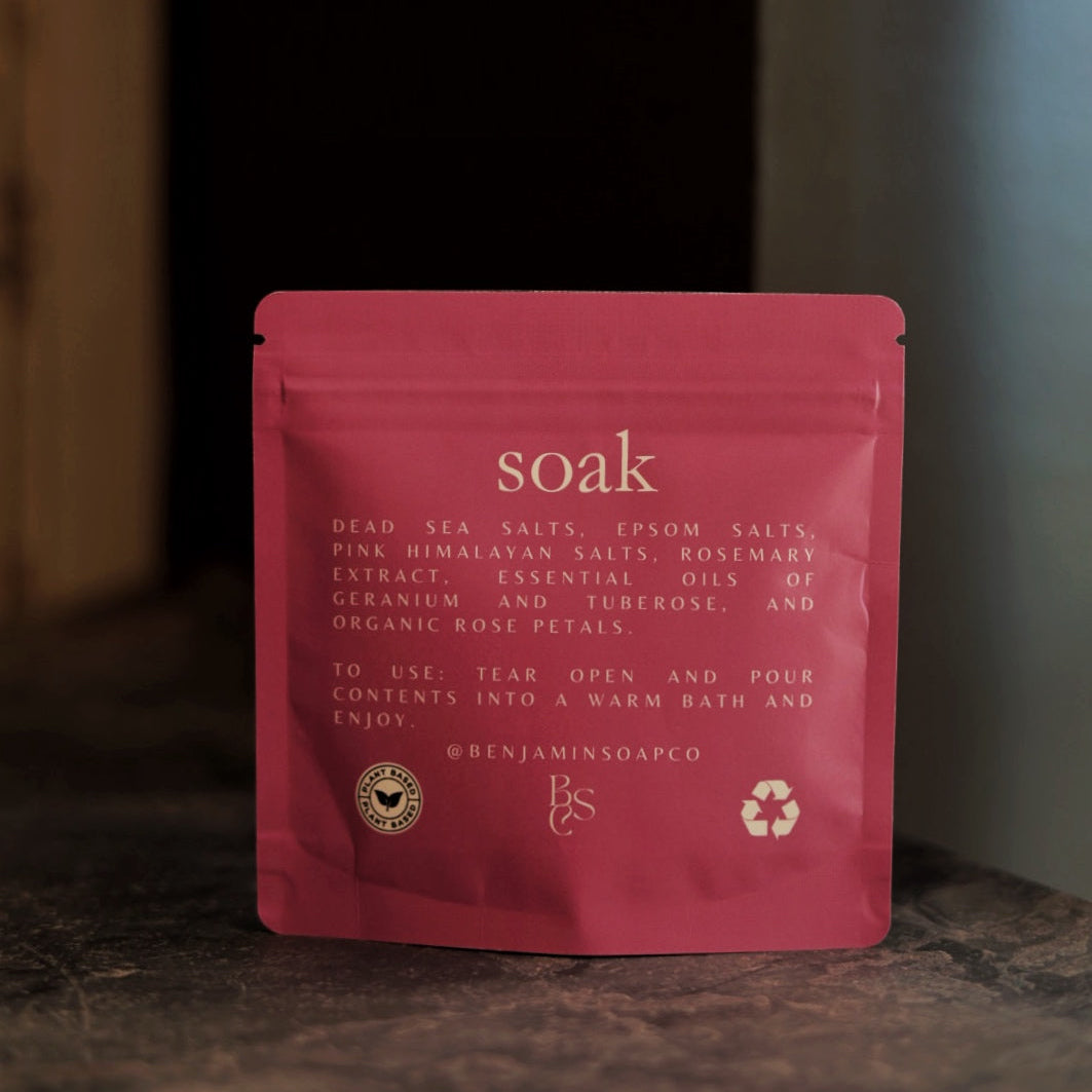 Red packet labeled 'soak' on a wooden surface with a blurred background