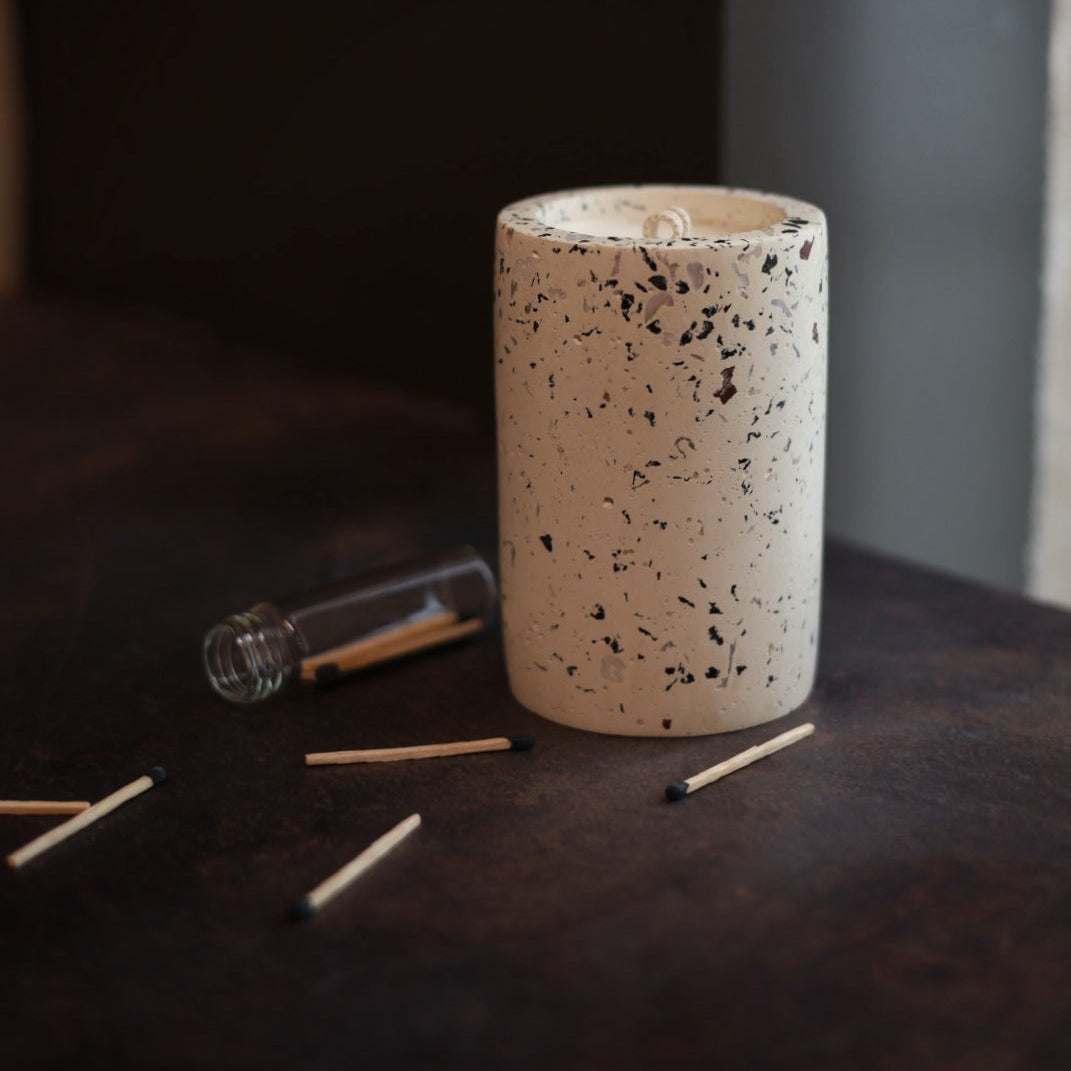 Volcano fragrance on a dark background with scattered matches