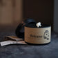 Candle labeled 'Volcano' with a blurred background